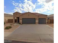 Charming single-story home with a tile roof, two-car garage, and low-maintenance landscaping at 1133 E Viola Ct, Casa Grande, AZ 85122