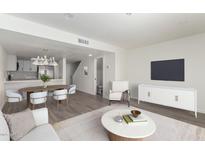 Bright living room featuring an open floor plan with a modern kitchen and stylish furniture at 122 S Hardy Dr # 62, Tempe, AZ 85281