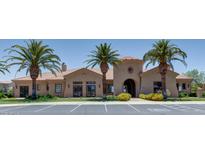 Community clubhouse with desert landscaping, palm trees, and ample parking at 1367 S Country Club S Dr # 1125, Mesa, AZ 85210