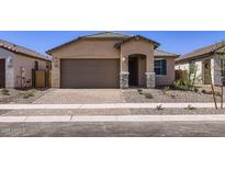 Charming single-story home featuring a paved driveway, neutral stucco, and a covered entryway at 15600 W Williams St, Goodyear, AZ 85338