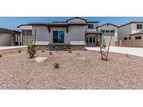 Charming two-story home featuring desert landscaping and a stone-accented facade at 17322 W Puget Ave, Waddell, AZ 85355