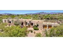 Expansive neutral home with desert landscaping, mountain views, and a three-car garage at 2304 Fox Tail Trl, Carefree, AZ 85377