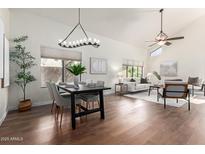 Bright open-concept living and dining area featuring wood floors and modern chandelier at 2635 N El Dorado Pl, Chandler, AZ 85224
