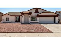 Charming home featuring a well-maintained exterior with a two-car garage and low-maintenance landscaping at 3408 N 69Th Dr, Phoenix, AZ 85033
