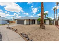 A lovely single-story home, featuring a wide driveway, with a two-car garage and xeriscaped front yard at 4226 W Evans Dr, Phoenix, AZ 85053