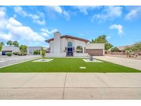 Stunning two-story home boasts charming curb appeal with a well-manicured lawn and elegant facade at 4601 E Carolina Dr, Phoenix, AZ 85032