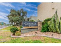 Camelback House Condominiums community sign featuring mature landscaping, cacti, and clear blue skies at 4610 N 68 N St # 476, Scottsdale, AZ 85251