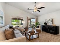 Cozy living room bathed in natural light features vaulted ceilings, a ceiling fan, and a comfortable sectional sofa at 810 E Potter Dr, Phoenix, AZ 85024
