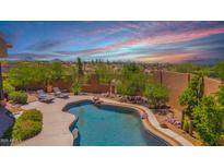 Inviting pool with lounge chairs surrounded by desert landscaping, offering a serene outdoor oasis at 8154 E Tecolote Cir, Scottsdale, AZ 85266