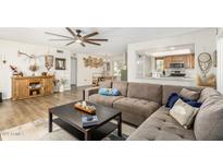 Bright living room featuring a large sectional sofa, ceiling fan, and an open view to the kitchen at 903 W Shawnee Dr, Chandler, AZ 85225
