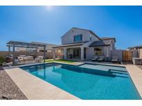 Gorgeous backyard pool with spa, covered patio, and lounge area, perfect for outdoor entertaining at 9645 E Ripple Dr, Mesa, AZ 85212