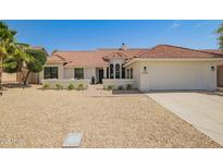 Charming single-story home with a well-manicured yard and a neutral color palette at 10155 E Wood Dr, Scottsdale, AZ 85260