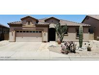 Inviting home featuring desert landscaping, a tile roof, and a two car garage at 10572 E Autumn Sage Dr, Scottsdale, AZ 85255