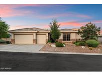 Well-maintained home featuring a three-car garage and manicured front yard with desert landscaping elements at 11193 N 121St Way, Scottsdale, AZ 85259