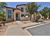 Inviting two-story home featuring neutral stucco, a gated entry, and low-maintenance desert landscaping at 14870 W Encanto Blvd # 1038, Goodyear, AZ 85395
