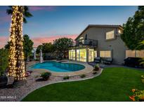 Beautiful backyard featuring a private pool, lush landscaping, and inviting patio area at 15411 S 13Th Ave, Phoenix, AZ 85045