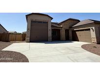 Beautiful, single-Gathering home with a three car garage and stone facade accents at 17308 W Royal Palm Rd, Waddell, AZ 85355