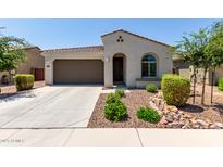 Charming single-story home with a well-maintained front yard and two-car garage at 19751 W Adams St, Buckeye, AZ 85326
