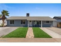 Charming single story home with manicured front yard, stone walkway and bench by front door at 2036 W Windrose Dr, Phoenix, AZ 85029