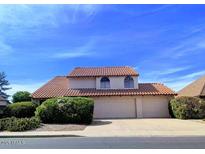 Charming two-story home with a tile roof, arched windows, and a well-manicured lawn at 2050 W Nido Ave, Mesa, AZ 85202
