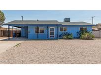 Charming single-story home featuring a covered porch, metalwork details, and low-maintenance landscaping at 2117 W 2Nd St, Mesa, AZ 85201
