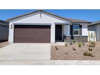 Charming single-story home featuring a two-car garage, stone accents, and a well-maintained gravel front yard at 3510 N Camden Dr, Florence, AZ 85132
