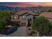 Charming two-story home featuring a tile roof, three-car garage, and landscaped front yard with mountain views at 4264 S Columbine Way, Gold Canyon, AZ 85118