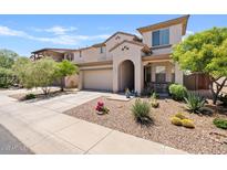 Charming two-story home with arched entryway, desert landscaping and two-car garage at 4427 W Powell Dr, New River, AZ 85087