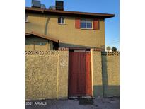 View of the home's facade, featuring a private gate and a charming, secure courtyard entrance at 4615 N 39Th Ave # 21, Phoenix, AZ 85019