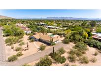 Sprawling property with desert landscaping, pool, and stunning mountain views, perfect for serene living at 6009 N Kachina Ln, Paradise Valley, AZ 85253