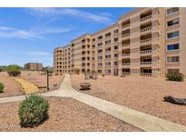 Low angle of residential building with balconies and desert landscaping at 7920 E Camelback Rd # 104, Scottsdale, AZ 85251