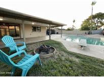 Inviting backyard with a fire pit, swimming pool, covered patio, and lounge chairs at 9615 N 34Th Ave, Phoenix, AZ 85051
