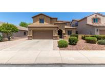 Inviting two-story home boasts a desert-landscaped front yard and a convenient two-car garage at 10910 E Sebring Ave, Mesa, AZ 85212