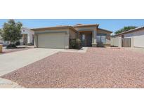 Charming single-story home featuring a two-car garage and low maintenance desert landscaping at 11548 W Cottonwood Ln, Avondale, AZ 85392