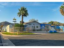 Charming fenced single-story home with mature landscaping, mountain views, and a unique desert charm at 1226 W Purdue Ave, Phoenix, AZ 85021