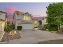 Charming two-story home boasts a tile roof, a spacious two-car garage and a well-maintained landscaped yard at 1405 N Jamaica Way, Gilbert, AZ 85234