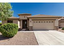 Charming single-story home featuring a two-car garage, well-maintained landscaping, and a welcoming entrance at 15429 W Ventura St, Surprise, AZ 85379