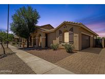 Beautiful single-story home boasts a well-manicured lawn, brick driveway, and attached two-car garage at 1960 S Falcon Dr, Gilbert, AZ 85295