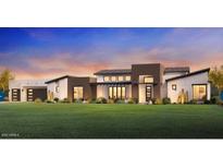 Stunning modern home with a manicured lawn and a dramatic sunset backdrop at 21963 E Sunset Dr, Queen Creek, AZ 85142
