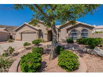 Charming single-story home featuring a well-manicured front yard and a two-car garage at 2422 E Rockledge Rd, Phoenix, AZ 85048