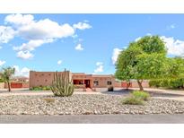 Single story home with desert landscaping, a large cactus and a circular driveway at 2699 E Claxton Rd, Gilbert, AZ 85297