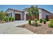 Attractive single-Gathering home with a neutral color palette, dual garages, and tidy landscaping at 31570 N 123Rd Ln, Peoria, AZ 85383