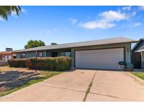 Charming single-story home with an attached two-car garage and beautiful desert landscaping at 3207 W Michigan Ave, Phoenix, AZ 85053
