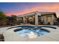 Backyard pool and covered patio with outdoor seating, perfect for relaxing or entertaining guests at 4413 W Phalen Dr, New River, AZ 85087