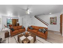 Inviting living room featuring a cozy seating area and stylish decor with hardwood floors and natural light at 4630 N 68Th St # 280, Scottsdale, AZ 85251