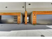 Modern home featuring stylish garage doors, with contemporary architecture, and well-maintained landscaping at 6525 E Cave Creek Rd # 101, Cave Creek, AZ 85331