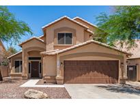 Charming two-story home featuring a tile roof, desert landscaping, and a two-car garage at 728 E Windsor Dr, Gilbert, AZ 85296