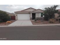Charming single-story home featuring a two-car garage and low maintenance desert landscaping in front at 7284 E Gamebird Way, San Tan Valley, AZ 85143