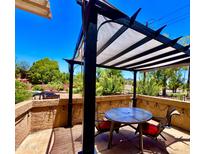 Inviting outdoor patio features a shaded pergola, comfortable seating, and views of the manicured backyard at 841 E Peoria Ave # 2, Phoenix, AZ 85020