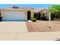 Inviting single-Gathering home featuring a well-maintained front yard and attached two-car garage at 8569 W Fullam St, Peoria, AZ 85382
